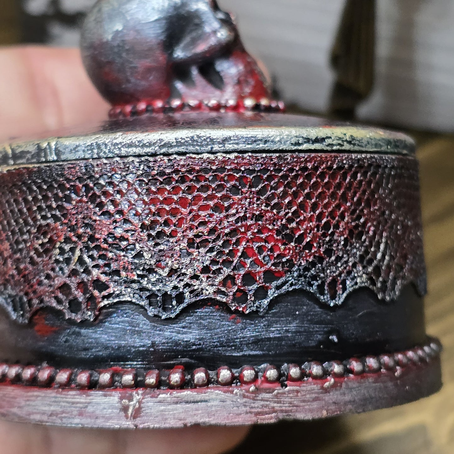 Das Bild zeigt eine gandgemachte Schmuckdose mit Totenkopf, Punk Stil, Rockabilly, Totenkopfliebe, Gothic Style
Ein Hauch von Dunkelheit und Rebellion erwartet dich mit dieser einzigartigen handgemachten Schmuckdose im unverwechselbaren Punk-Gothic-Stil.