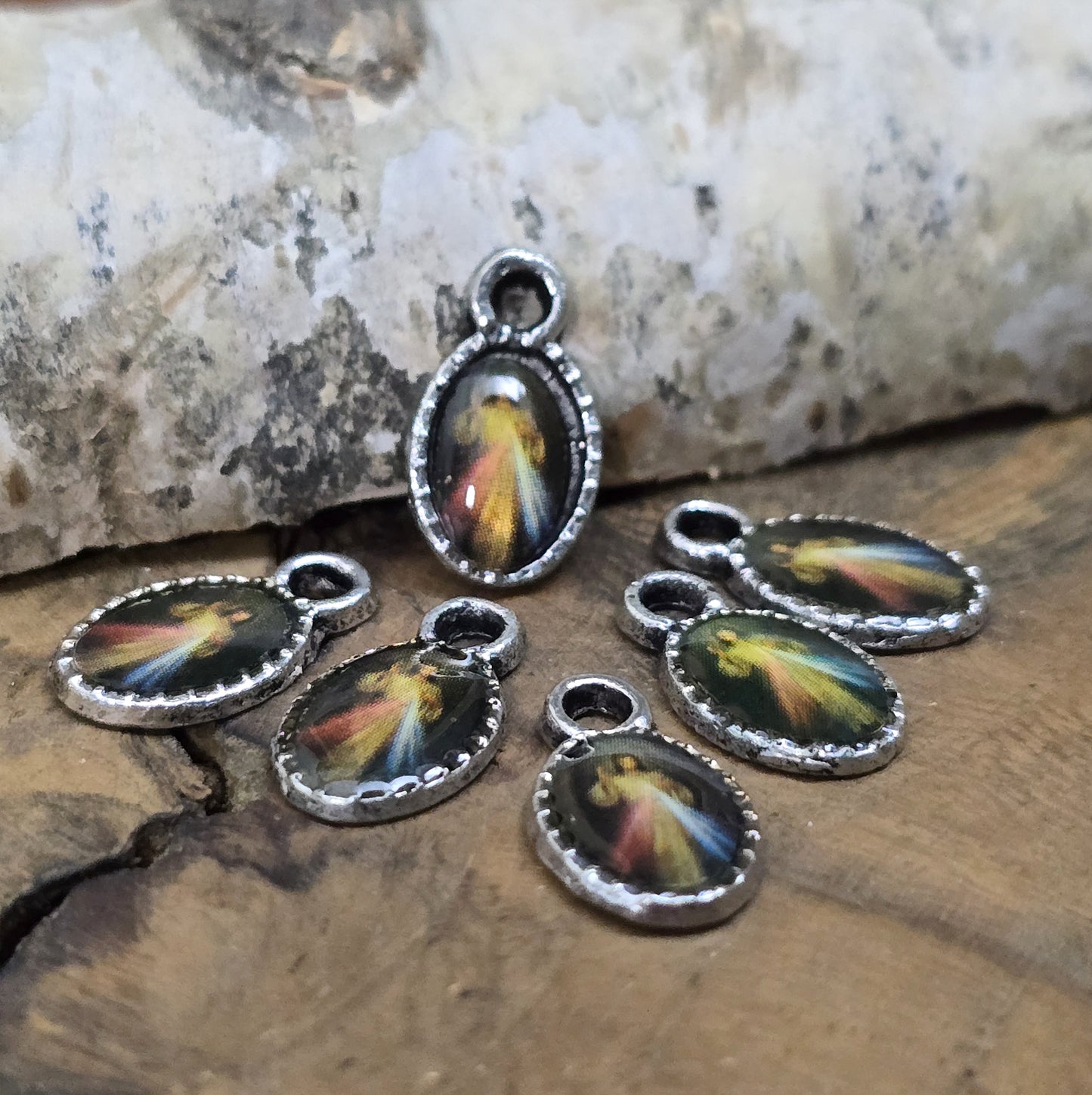 Diese kleinen Anhänger zeigen ein Bildnis von Jesus. Das Bild ist versiegelt mit Kunstharz um es vor Beschädigungen zu schützen. Auf der Rückseite befindet sich ein Kreuz. Ideal für Armbänder, Ohrschmuck und andere kreative Anwendungen. 