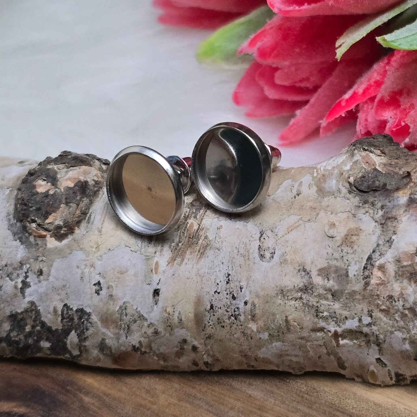 Das Bild zeigt Ohrstecker mit runder Klebewanne aus 304 Edelstahl, passend für 10mm Cabochons in silberfarbig