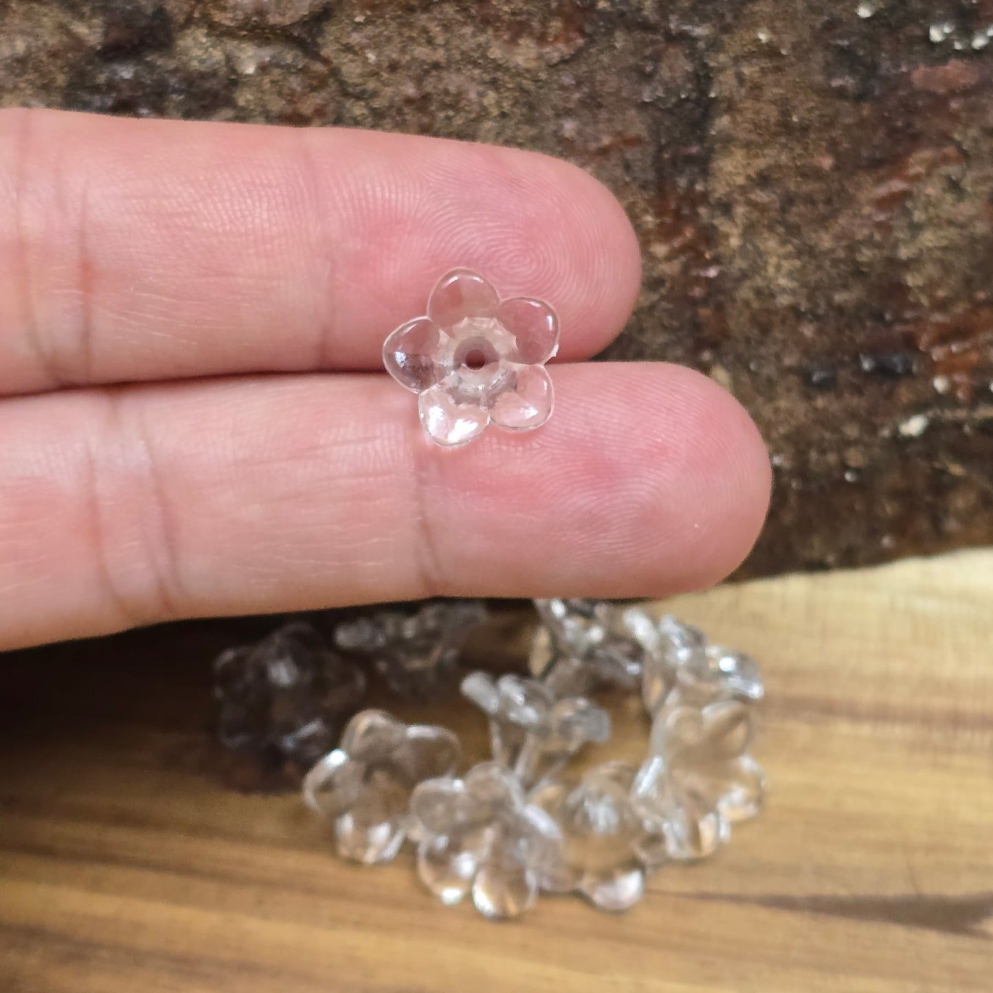 Transparente Blumenperlen aus Acryl (12 mm) mit glänzender Oberfläche. Die filigrane Blütenform verleiht Schmuckstücken, Makramee-Projekten und Deko-Ideen einen eleganten Touch. Dank des ca. 1,5 mm großen Fädellochs lassen sie sich leicht auf Schnüre oder Bänder aufreihen. Ideal für Hochzeiten, Taufen oder kreative Bastelarbeiten. Set enthält 50 Stück.