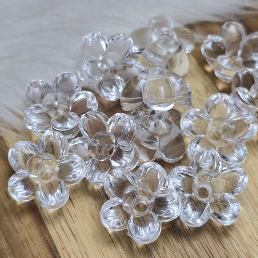 Klar transparente Acryl-Blumenperlen (18 mm) mit glänzender Oberfläche. Die filigrane Blütenform verleiht Schmuckstücken und Dekorationen eine elegante Note. Mit einem 3,5 mm großen Fädelloch lassen sie sich leicht auf Bänder oder Schnüre auffädeln. Ideal für DIY-Projekte, Hochzeiten oder Bastelarbeiten.