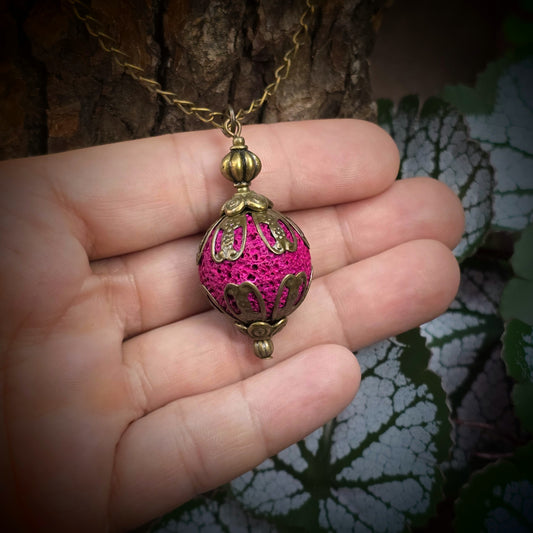 Lange Vintage Halskette (76cm) mit pinker Lavakugel (2cm) & bronzefarbenen Metallelementen. Handgefertigt, ohne Verschluss, einfach überziehbar. Leichter Vintage-Statement-Schmuck.