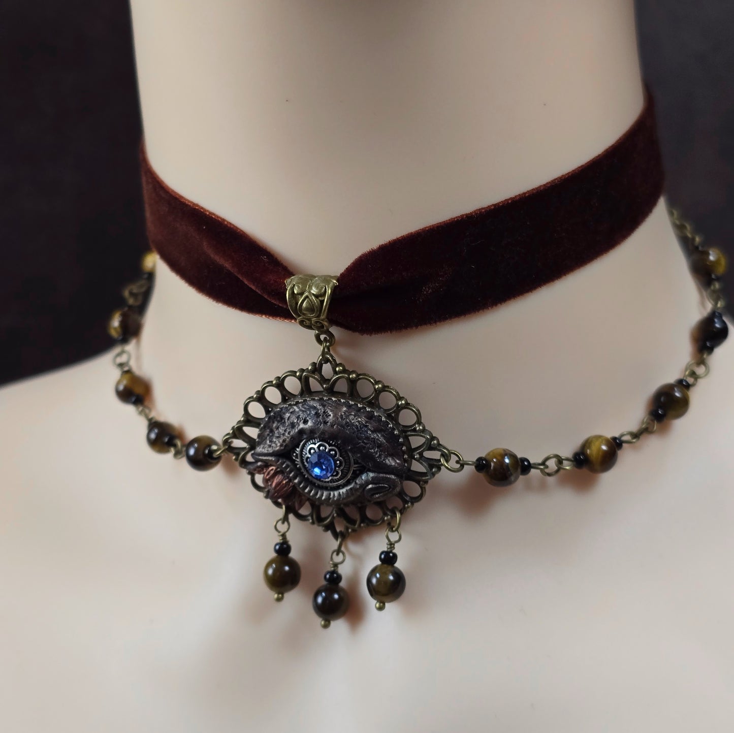 Mystischer Samtchoker in Braun mit handmodelliertem Drachenauge & Tigerauge-Perlen. Handmade Fantasy-Schmuck mit Layer-Ketten & Justierkette.