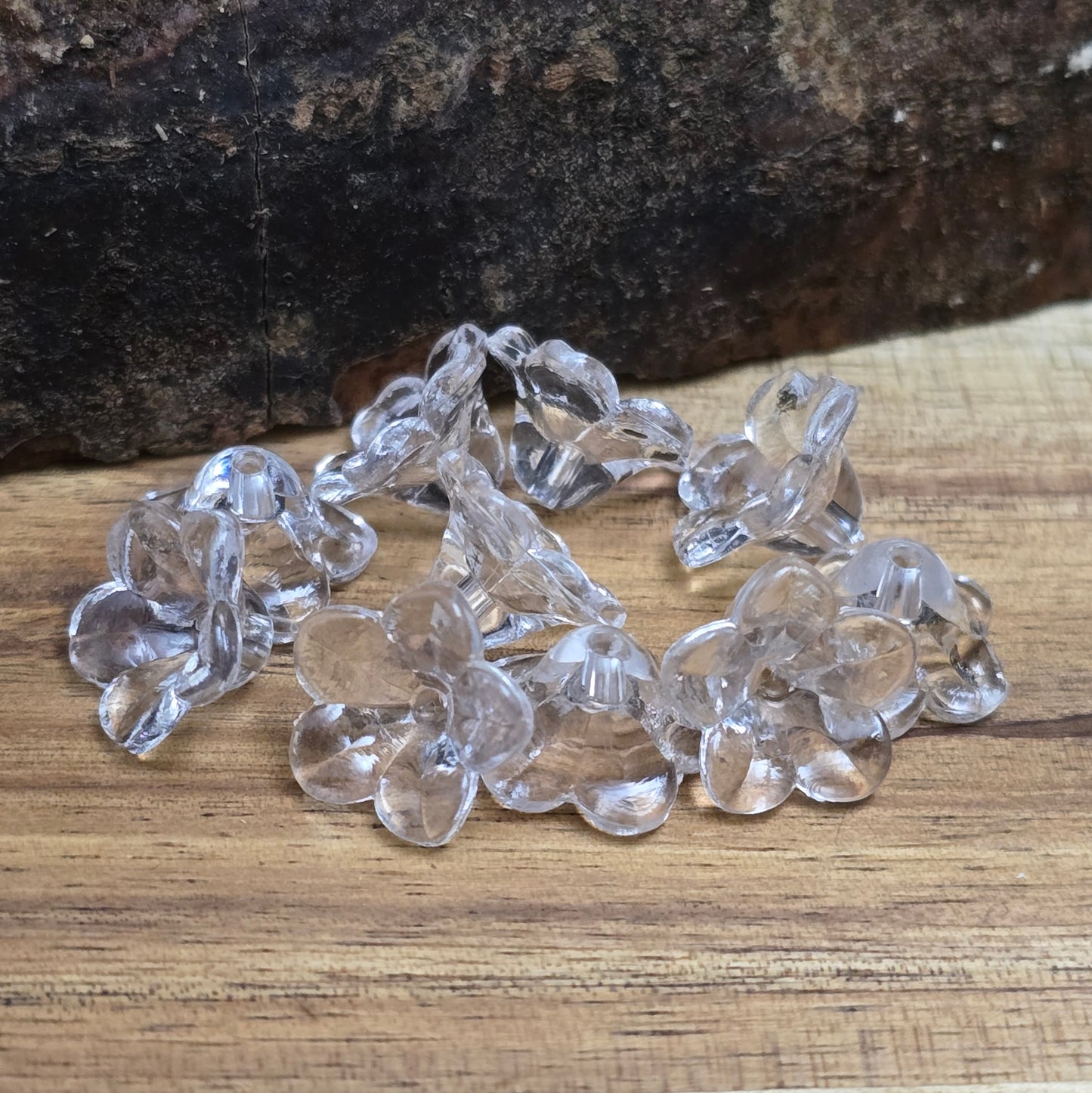 Transparente Blumenperlen aus Acryl (12 mm) mit glänzender Oberfläche. Die filigrane Blütenform verleiht Schmuckstücken, Makramee-Projekten und Deko-Ideen einen eleganten Touch. Dank des ca. 1,5 mm großen Fädellochs lassen sie sich leicht auf Schnüre oder Bänder aufreihen. Ideal für Hochzeiten, Taufen oder kreative Bastelarbeiten. Set enthält 50 Stück.