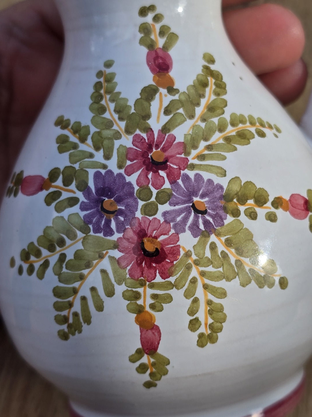 Kleiner Keramik-Zierkrug mit Mid-Century-Charakter, handgemaltem Blumendekor, rosa Rand, schmalem Hals und gutem Zustand ohne Beschädigungen.