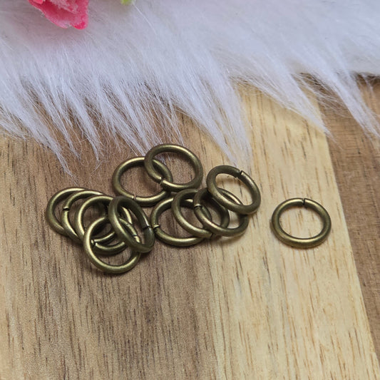 Das Bild zeigt 12 offene Biegeringe in antik bronzefarbig mit einem Durchmesser von 8mm. Die Verbindungsringe sind ein unverzichtbares Zubehör für die Schmuckherstellung. Ideal um Charms und Verschlüsse zuverlässig zu befestigen.