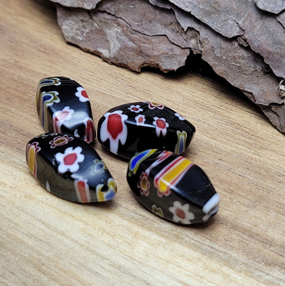 4 wunderschöne Millefiori Glasperlen in charmanter Nuggetform. Diese faszinierenden schwarzen Perlen sind perfekt für die Schaffung einzigartiger und individueller Schmuckstücke. Sie eignen sich hervorragend für die Gestaltung von Ketten, Armbändern und Ohrringen.