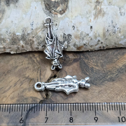 2 antik silberne Charms, hängende Fledermaus in Detailansicht, mit Lineal zur besseren Größenübersicht