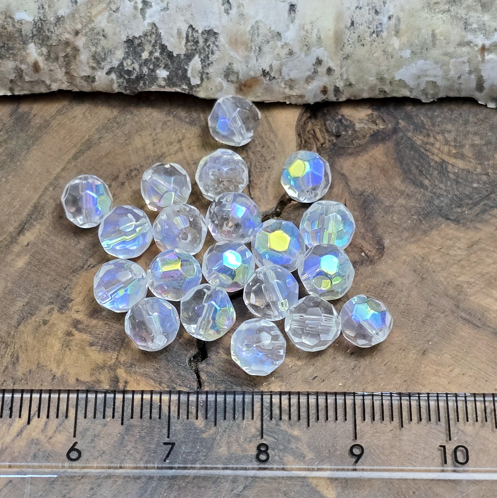 Das Bild zeigt 40 kleine facettierte Glasperlen – Kugel – 6mm – Crystal AB – Funkelnde Eleganz für deine Schmuckkreationen
