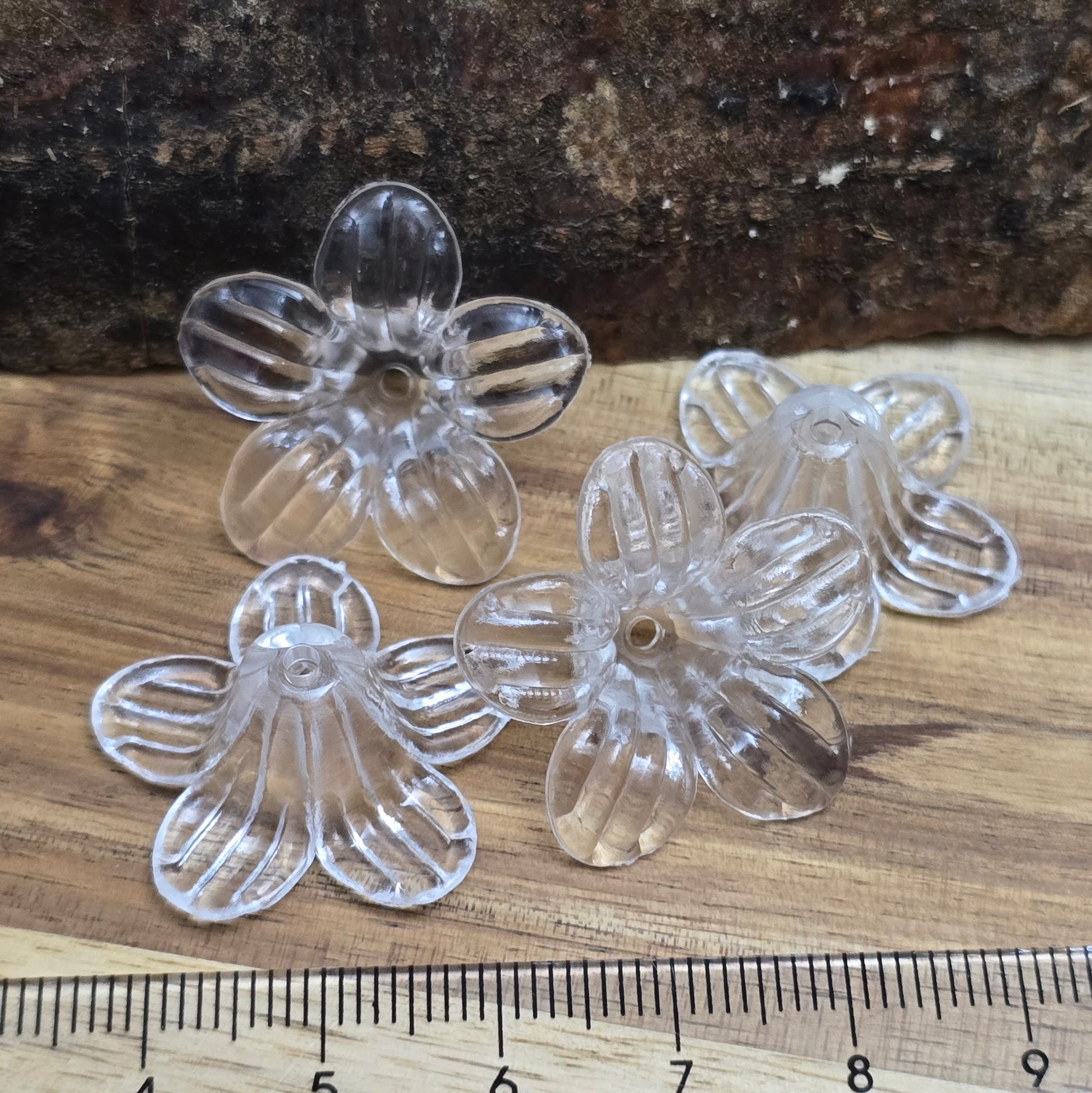 Transparente Acryl-Blumenperlen (25 mm) mit glänzender Oberfläche – ideal für Schmuck, Makramee und kreative Dekorationen. Dank des 2 mm großen Fädellochs lassen sie sich mühelos auffädeln. Perfekt als stilvolle Tischdeko für Hochzeiten, Taufen oder Sommerfeste und ein eleganter Akzent für jedes DIY-Projekt.
