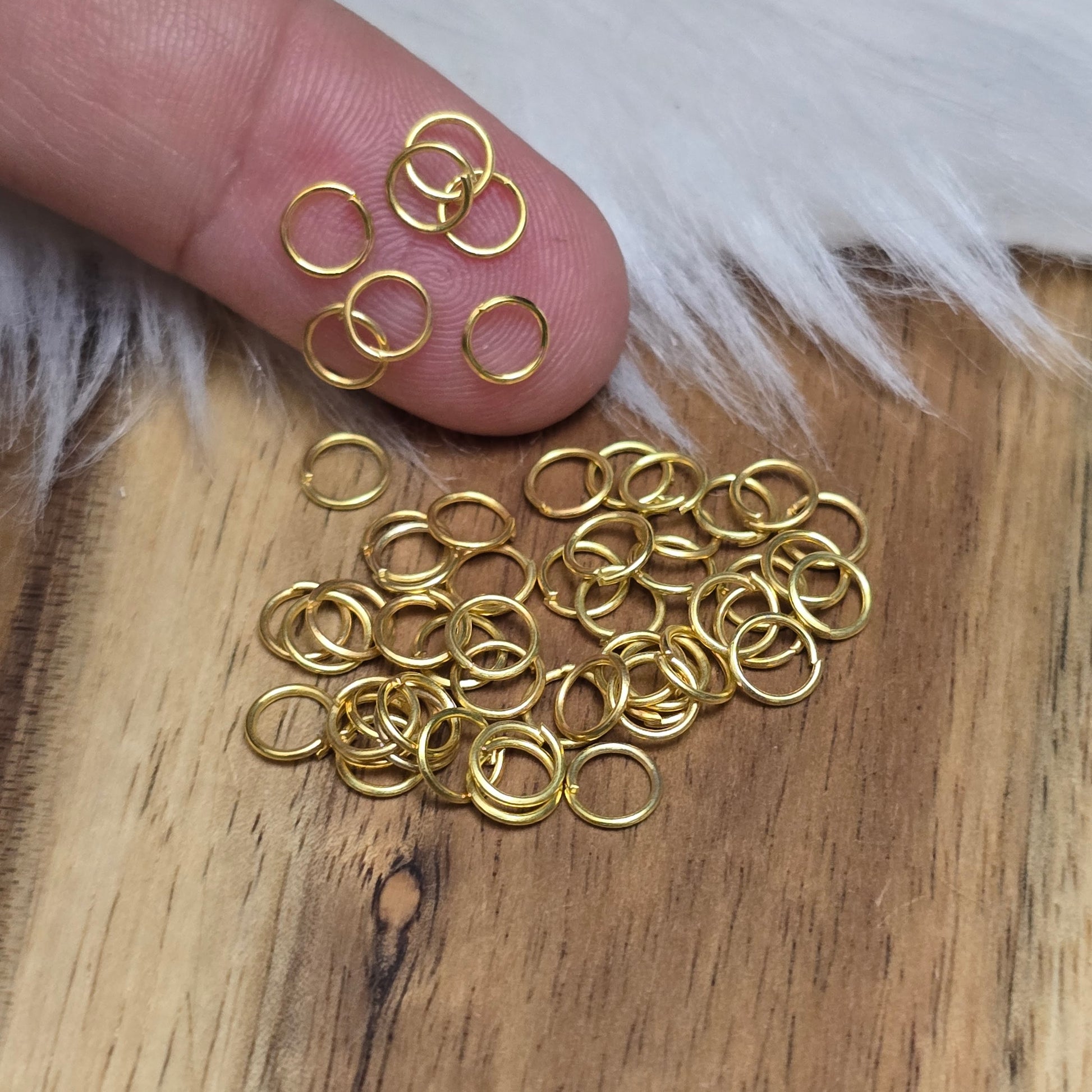 Das Bild zeigt 50 offenen Biegeringe in vergoldet mit einem Durchmesser von 5mm, ein unverzichtbares Zubehör für die Schmuckherstellung. Ideal um Charms und Verschlüsse zuverlässig zu befestigen.