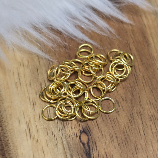 Das Bild zeigt 50 offenen Biegeringe in vergoldet mit einem Durchmesser von 5mm, ein unverzichtbares Zubehör für die Schmuckherstellung. Ideal um Charms und Verschlüsse zuverlässig zu befestigen.