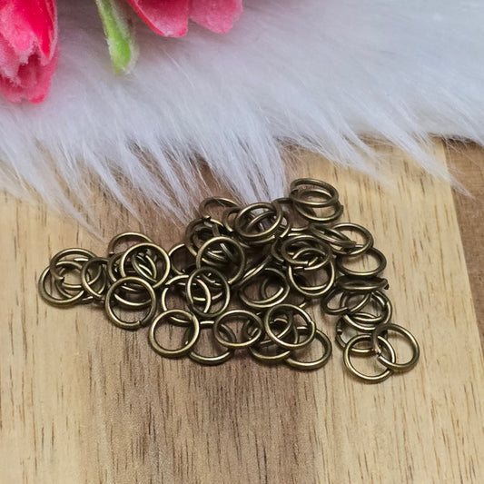 Das Bild zeigt 50 offene Biegeringe in antik bronzefarbig mit einem Durchmesser von  sind ein unverzichtbares Zubehör für die Schmuckherstellung. Ideal um Charms und Verschlüsse zuverlässig zu befestigen.,5mm. Die Verbindungsringe 