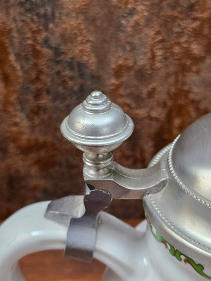 Ein klassisches Bierseidel aus Porzellan mit Zinndeckel, herausgegeben anlässlich des 25-jährigen Firmenjubiläums bei DATEV.