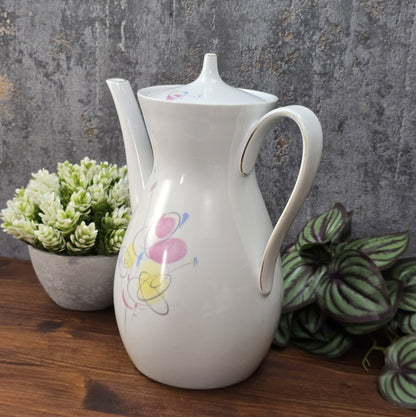 Mid-Century Kaffeekanne von Schirnding Bavaria aus weißem Porzellan mit pastellfarbenem Atomic-Dekor und zarter Goldlinie, ca. 1955–1965.