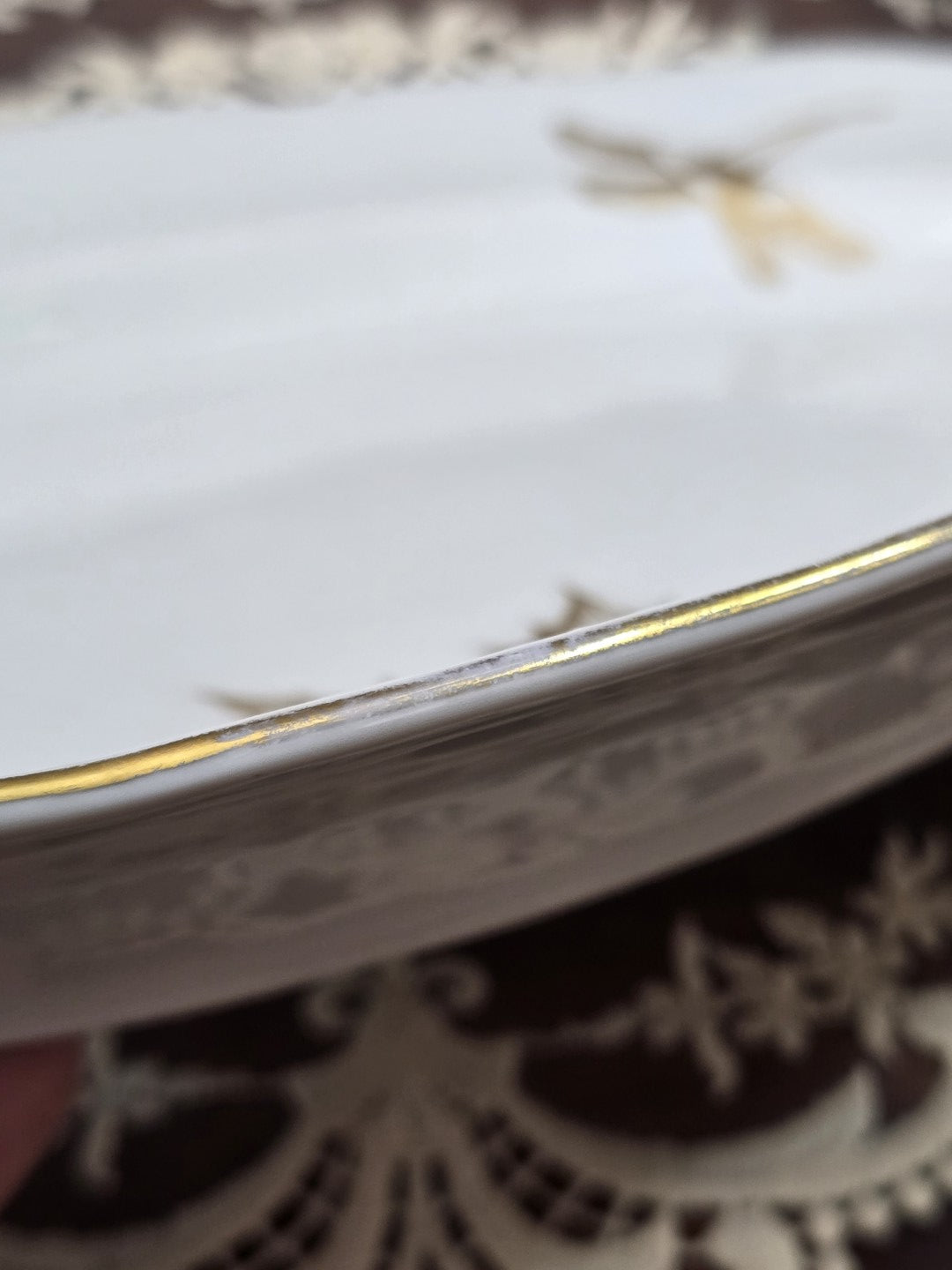 Freiberger Porzellan Servierplatte mit kleinem goldenen Blattmotiv und geschwungenem Rand in Detailansicht