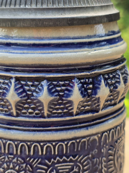 Nahaufnahme der blauen Glasur, Reliefstruktur und Gebrauchsspuren an einem Steinzeug Bierseidel