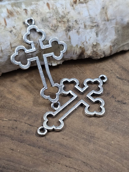 Zwei überkreuzte antike silberne Kreuz-Schmuckverbinder (35 mm) zur Ansicht der Ösen und der feinen Metall-Struktur.