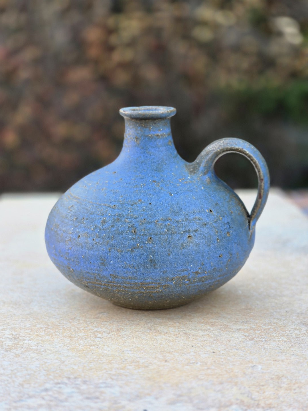 Signierte blaue Studiokeramikvase von Rudi Stahl aus Höhr-Grenzhausen, bauchige Form mit Henkel, matte Oberfläche und rotbraunem Scherben, wohl 1960er bis frühe 1970er Jahre.