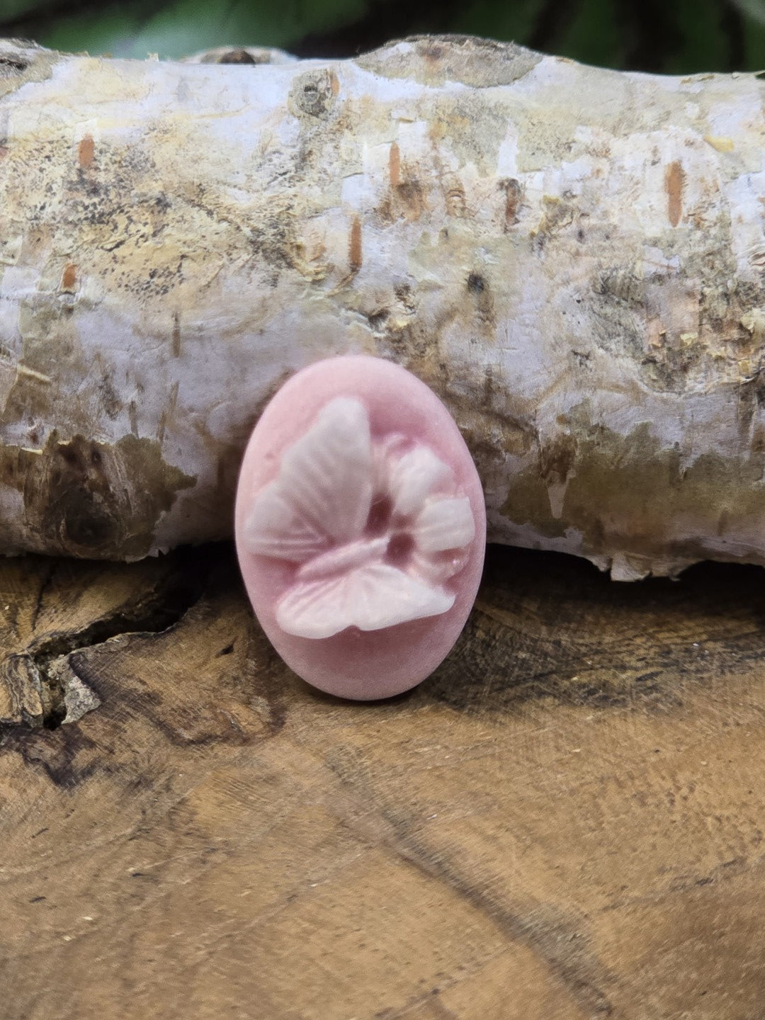Detailaufnahme eines altrosa Schmetterling Cabochons mit reliefartigem Motiv