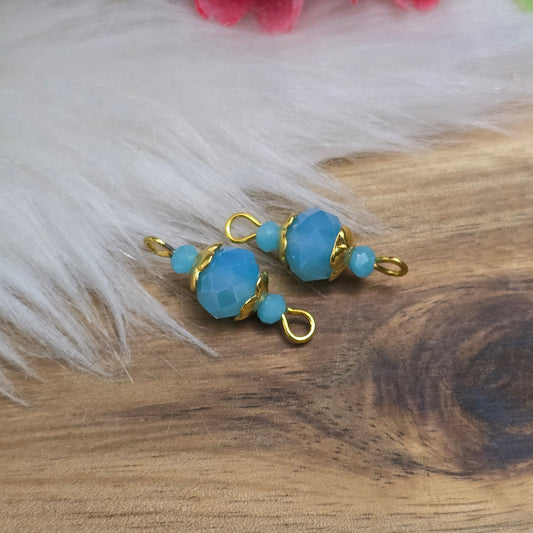 Das Bild zeigt zwei handgefertigte Verbinder mit denen du deinen persönlichen Schmuck aufpeppen kannst! Die funkelnden, facettierten Kristallglasperlen strahlen eine dezente Wärme aus und harmonieren perfekt mit den vergoldeten Metallelementen.