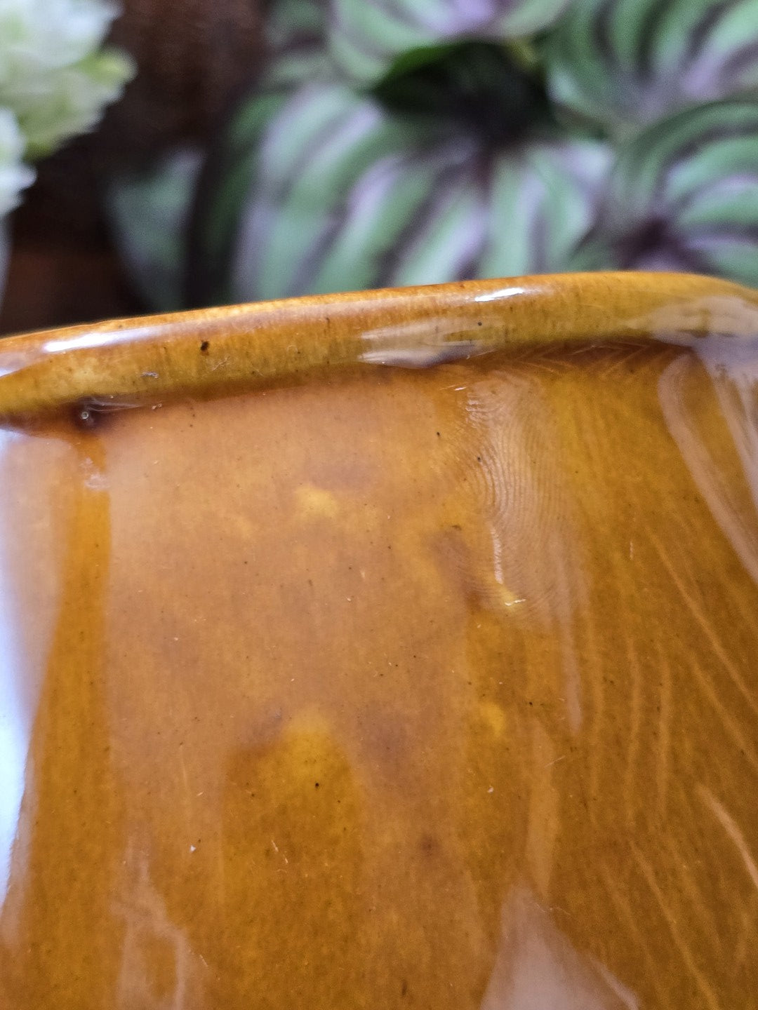 Vintage Keramik Milchkännchen mit honigbrauner Glanzglasur und leicht unregelmäßigem Rand in vergrößerter Detailaufnahme