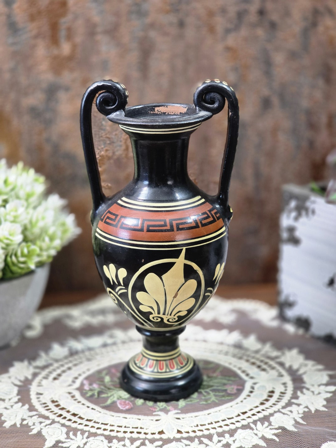 Vintage Keramikamphora mit cremefarbenem Palmettenmotiv, Mäanderband und zwei geschwungenen Henkeln auf Spitzendecke