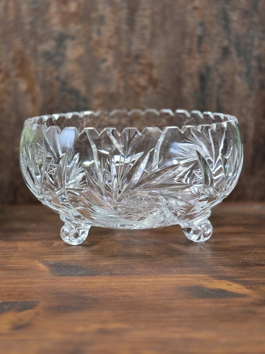 Klare Vintage Kristallglasschale mit geschliffenen Blatt- und Sternmotiven, gezacktem Rand und drei kleinen Glasfüßen.