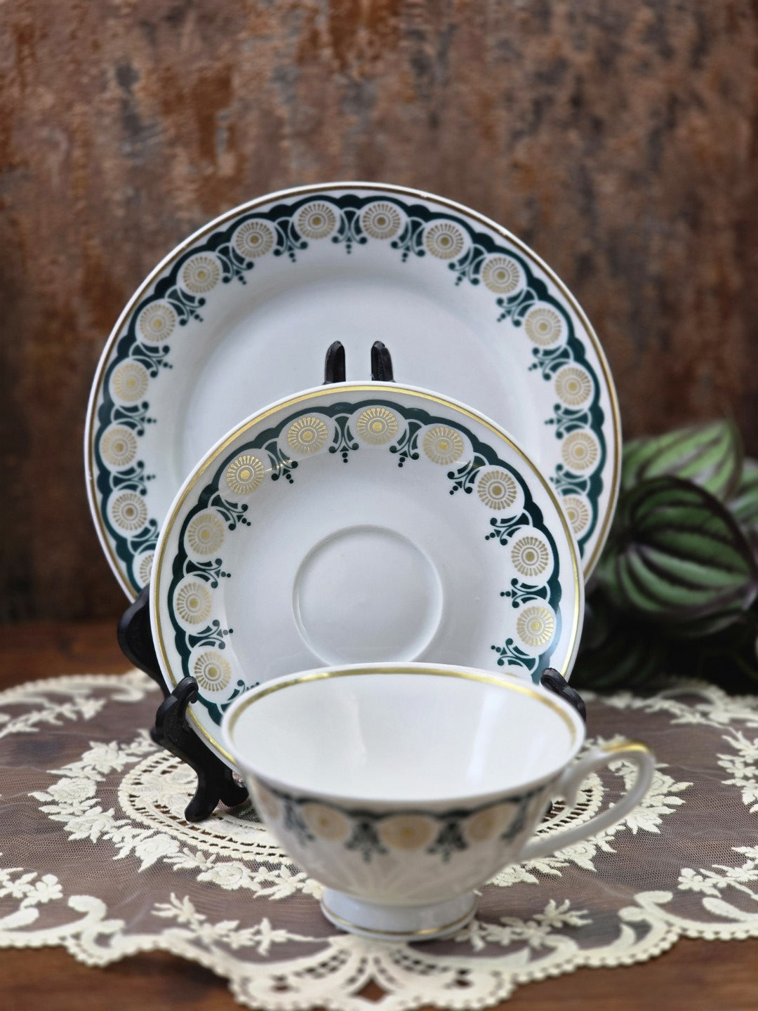 Vintage Lettin Porzellangedeck mit Tasse, Untertasse und Teller, grün-goldenem Randdekor in gestellter Ansicht