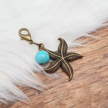 Charms Anhänger, Seestern, blauer Howlith, antik bronzefarbig